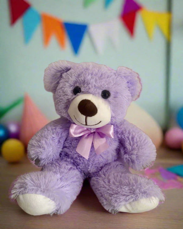 Purple teddy bear with a pink bow in a colorful setting