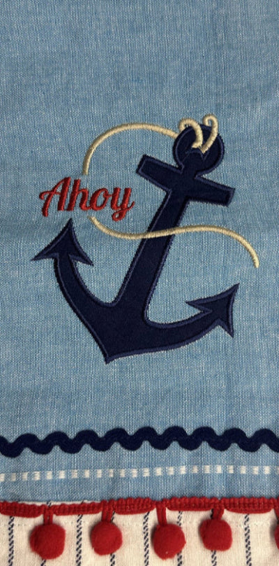 Nautical-themed towel with anchor and 'Ahoy' text on a blue background