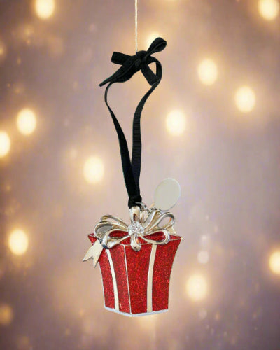 Red gift box ornament with a black ribbon on a white background