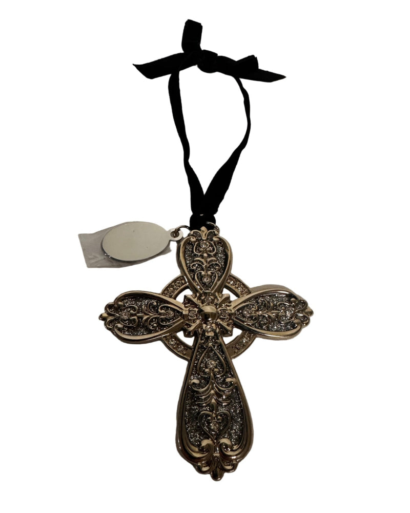 Decorative cross ornament with intricate designs on a white background