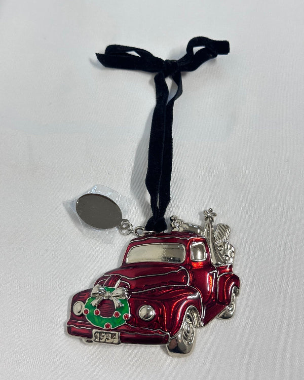 Red and silver car ornament with a black ribbon on a white background