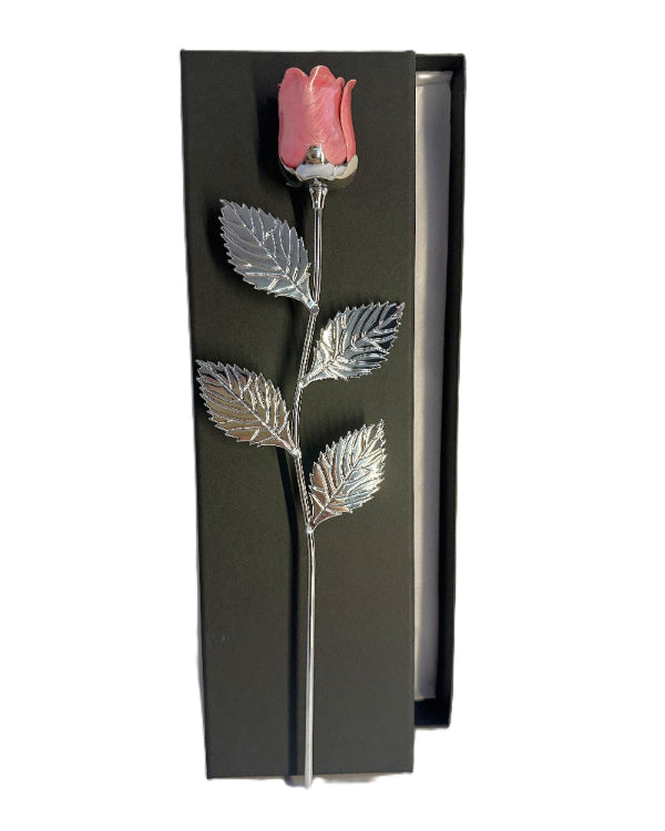 Decorative pink rose with silver leaves on a black background