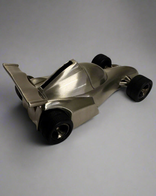 Metallic toy car on a gray background