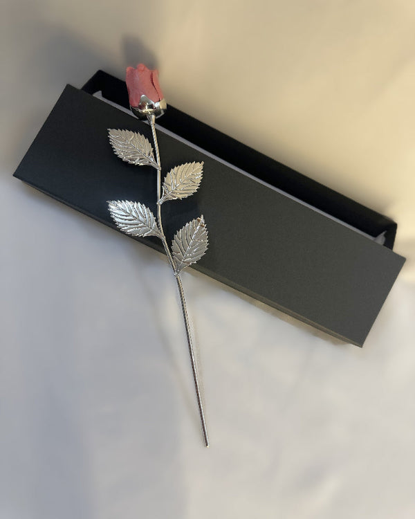 Silver leafed decorative item with pink top on a black Gift ready
