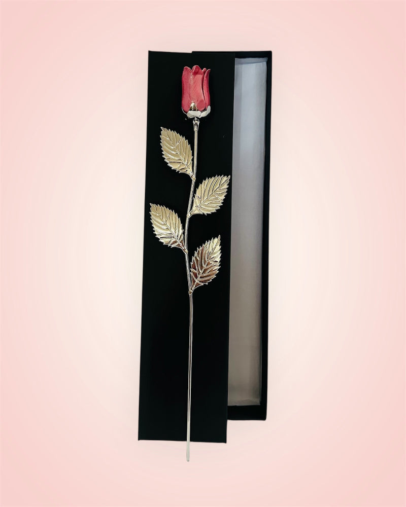 Decorative rose with gold leaves in a black box gift