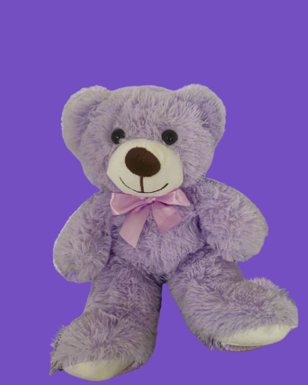 Purple teddy bear with a pink bow on a white background