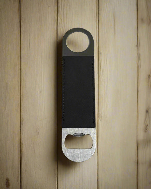 Bottle opener with leather strap on a wooden background