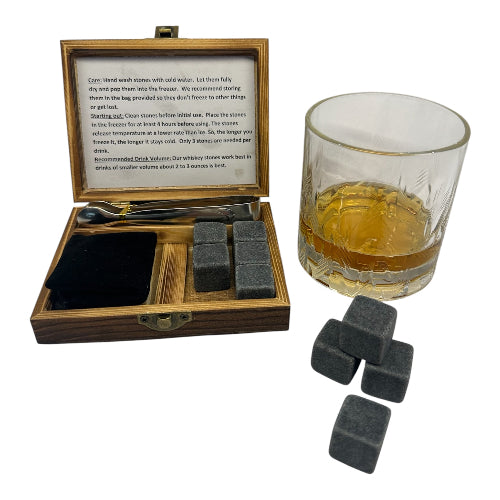 Whiskey stones set with a wooden box and a glass of whiskey on a white background