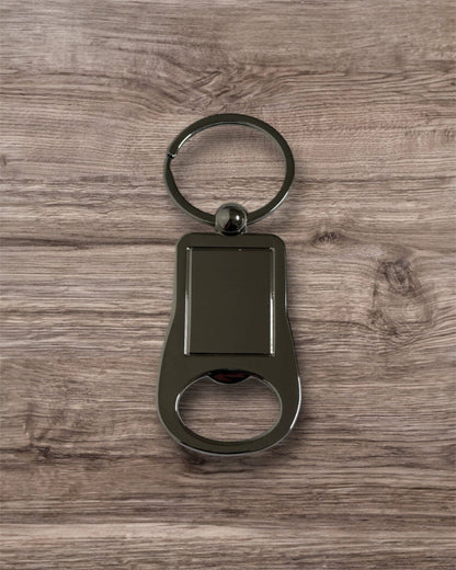 Metallic keychain with bottle opener on a wooden surface