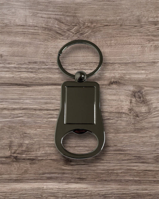 Metallic keychain with bottle opener on a wooden surface