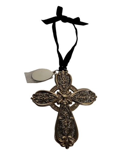 Decorative cross ornament with intricate designs on a white background