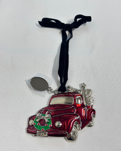 Red and silver car ornament with a black ribbon on a white background
