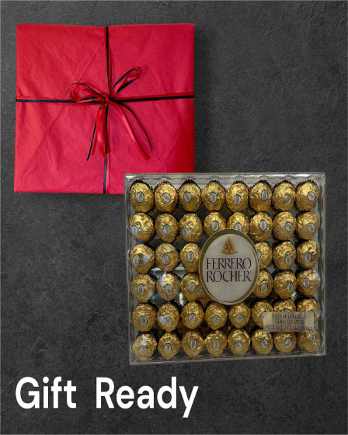 Box of Ferrero Rocher chocolates with a red gift box on a dark background