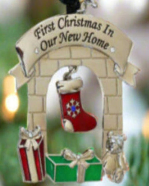 Christmas ornament with 'First Christmas in Our New Home' text, red boot, presents, and baby carriage on a white background.