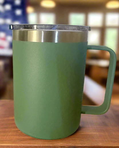 Green mug with a silver lid on a white box