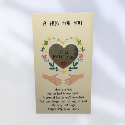 Card with a heart-shaped pocket hug and text on a beige background