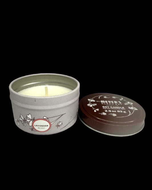 Meyers lavender candle in a tin with lid on a purple background