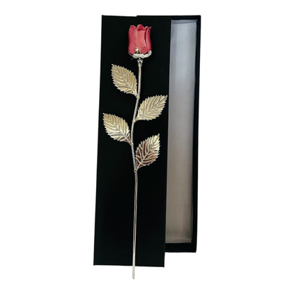 Decorative red rose with gold leaves in a black gift box