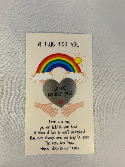 Card with rainbow, cloud, and heart design on a gray background