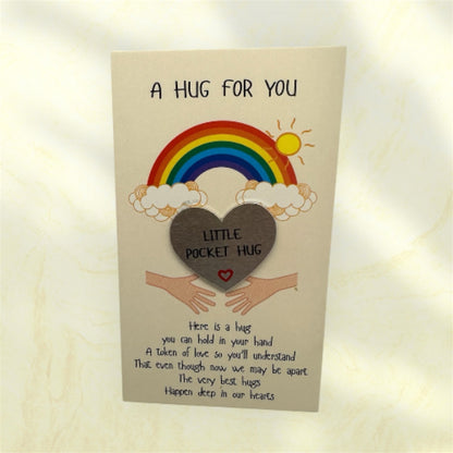 Card with a rainbow, heart, and text on a beige background