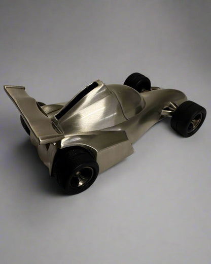 Metallic toy car on a gray background