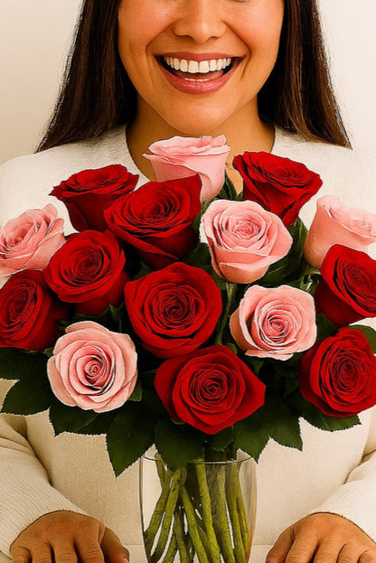 Woman holding a vase of red and pink roses against a plain background,  Happy receiving flower delivery.