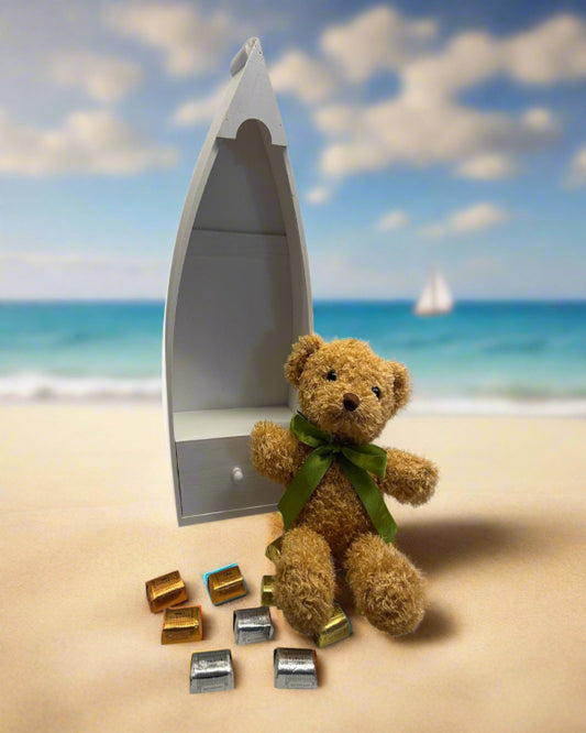 Teddy bear sitting in boat with assorted Hershey’s chocolates – tribute gift set for military families