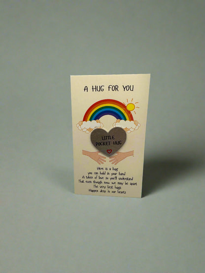 Card with a rainbow, heart, and text on a gray background