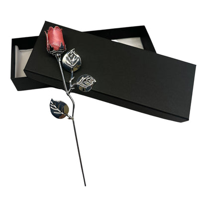 Silver rose with pink gem in a black box on a white background
